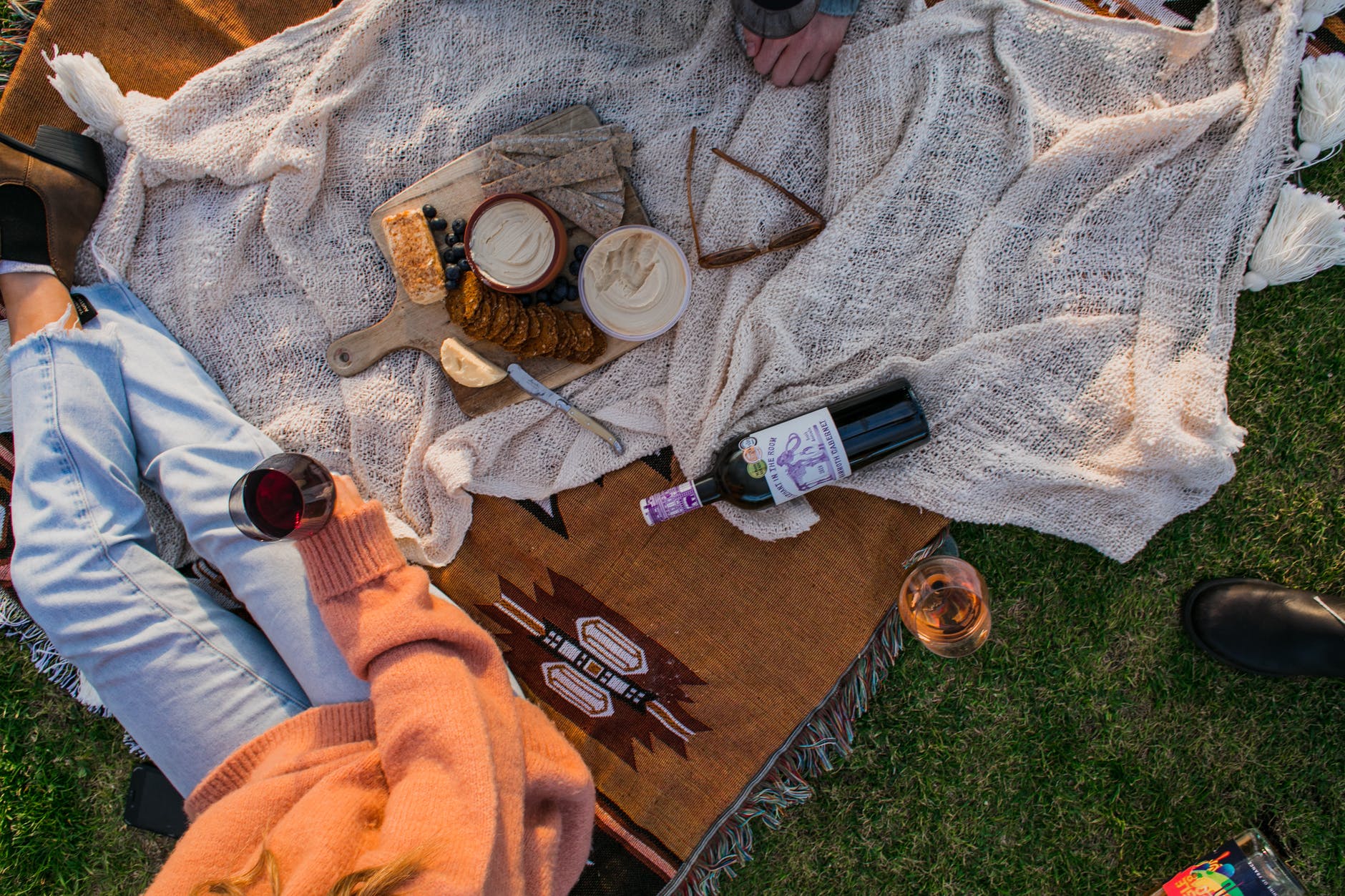 crop woman having picnic with wine